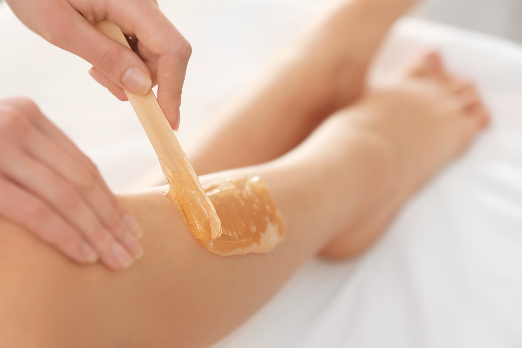 Applying wax to remove unwanted hair