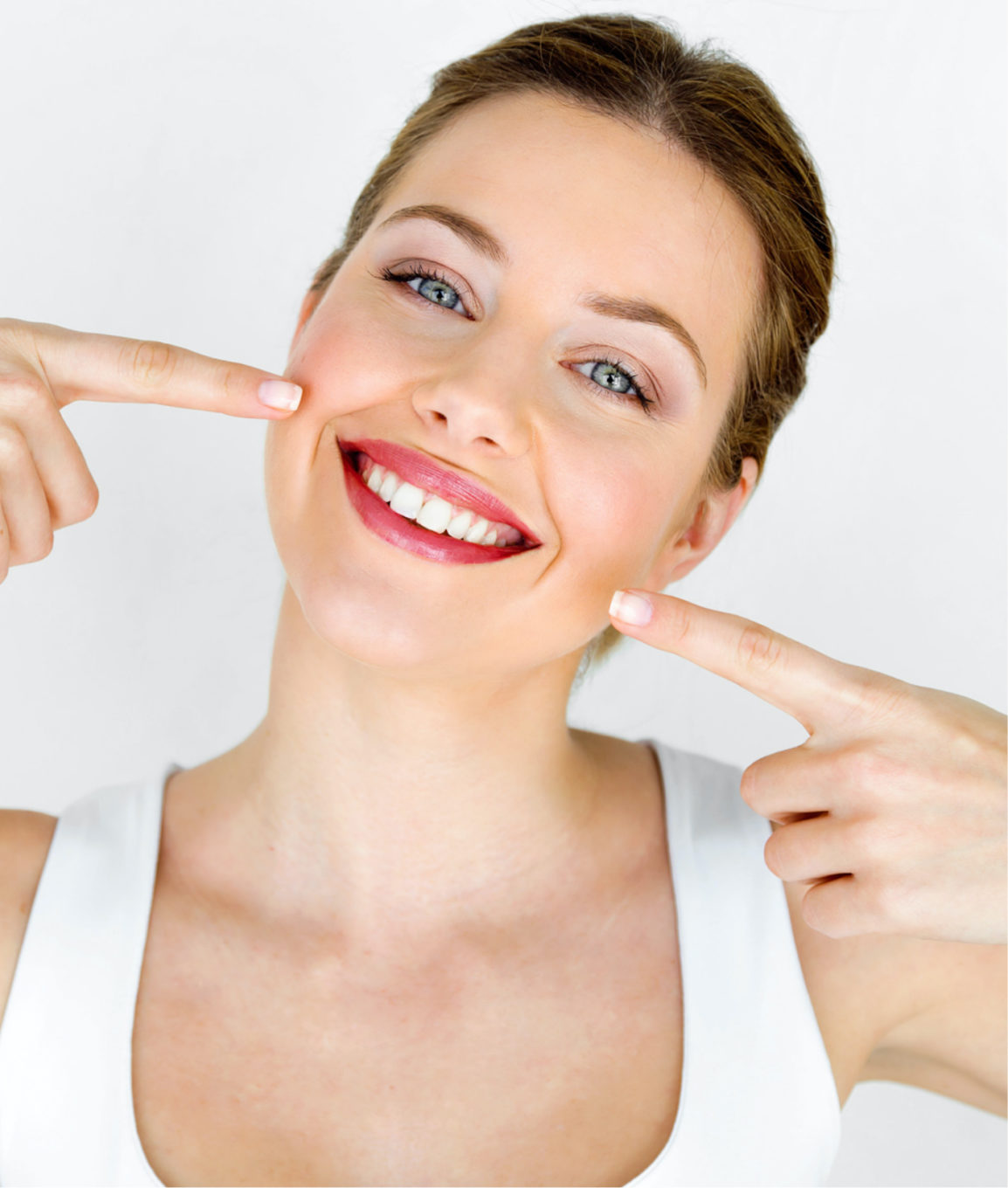 Happy woman with great skin pointing at her face