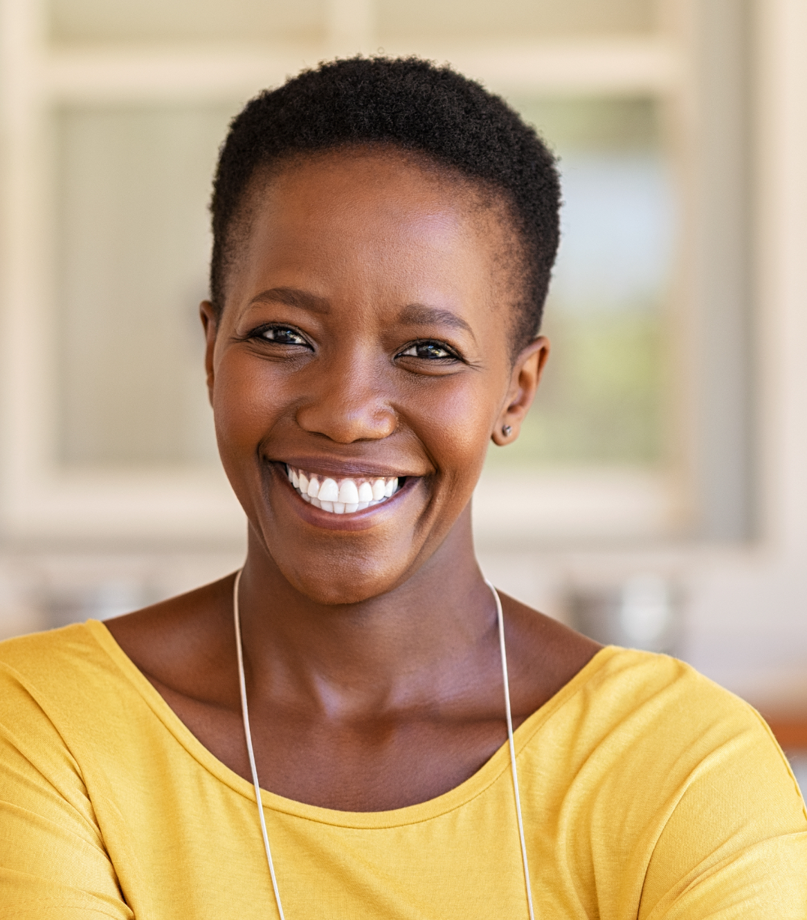 Smiling woman wearing a yellow shirt