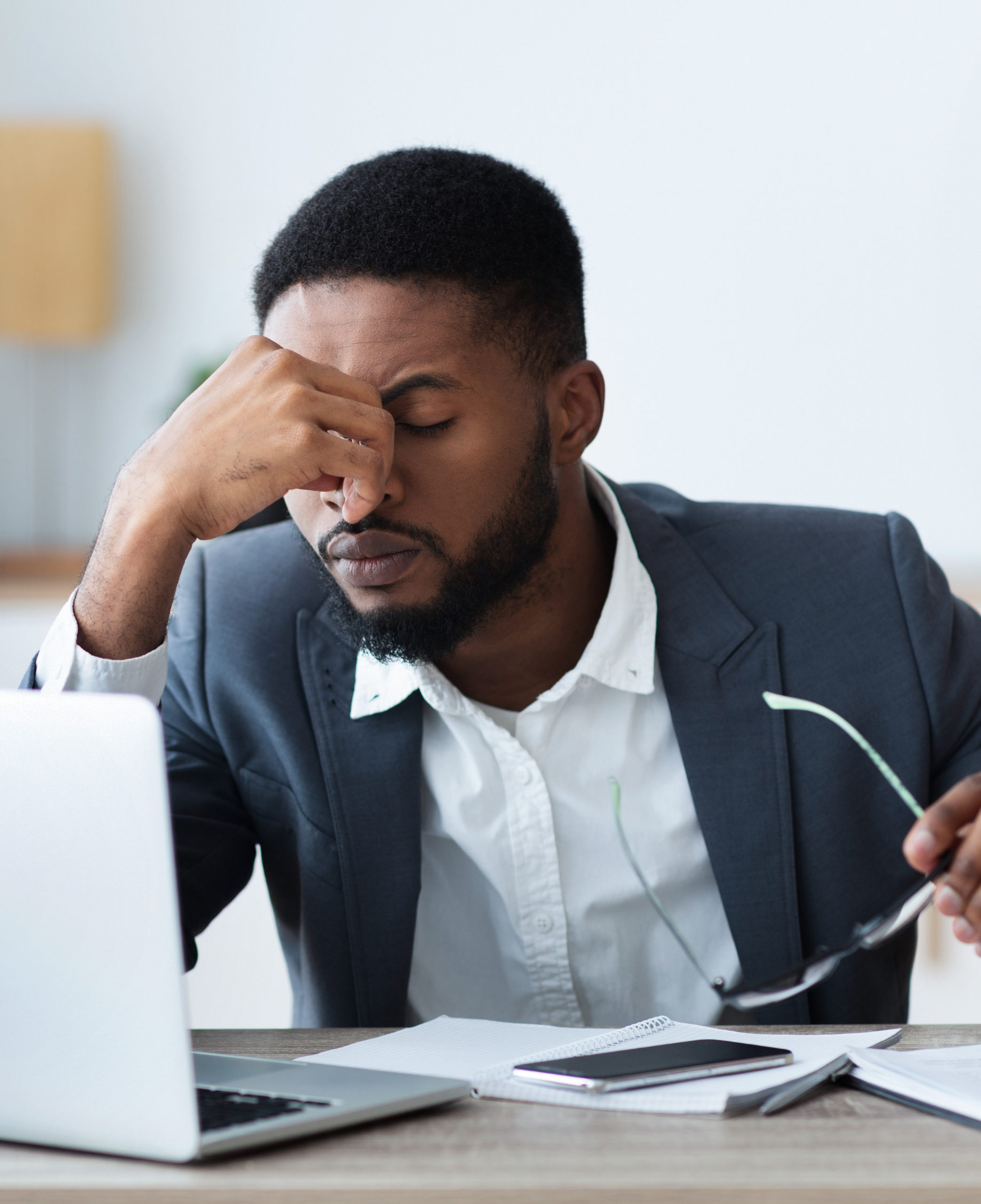 Businessman dealing with a migraine at work